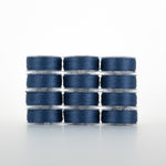 Twelve spools of navy blue thread arranged in four rows of three, each on clear plastic bobbins