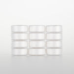 White 50 weight polyester thread on small white spools arranged in a 4x3 grid against light background