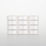 White 50 weight polyester thread on small white spools arranged in a 4x3 grid against light background