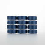 Twelve clear plastic bobbins of navy blue thread stacked in a 4x3 grid formation