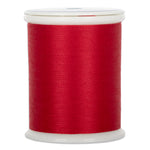 Red thread wound on white plastic spool with clear plastic top and bottom caps