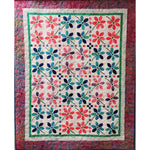 Colorful floral quilt with appliqued flowers in pink, blue, and teal on cream background with decorative border and small square accents.
