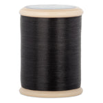 Black hand quilting thread wound on wooden spool with beige plastic ends and gray label on top