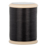 Black hand quilting thread wound on wooden spool with beige plastic ends and gray label on top