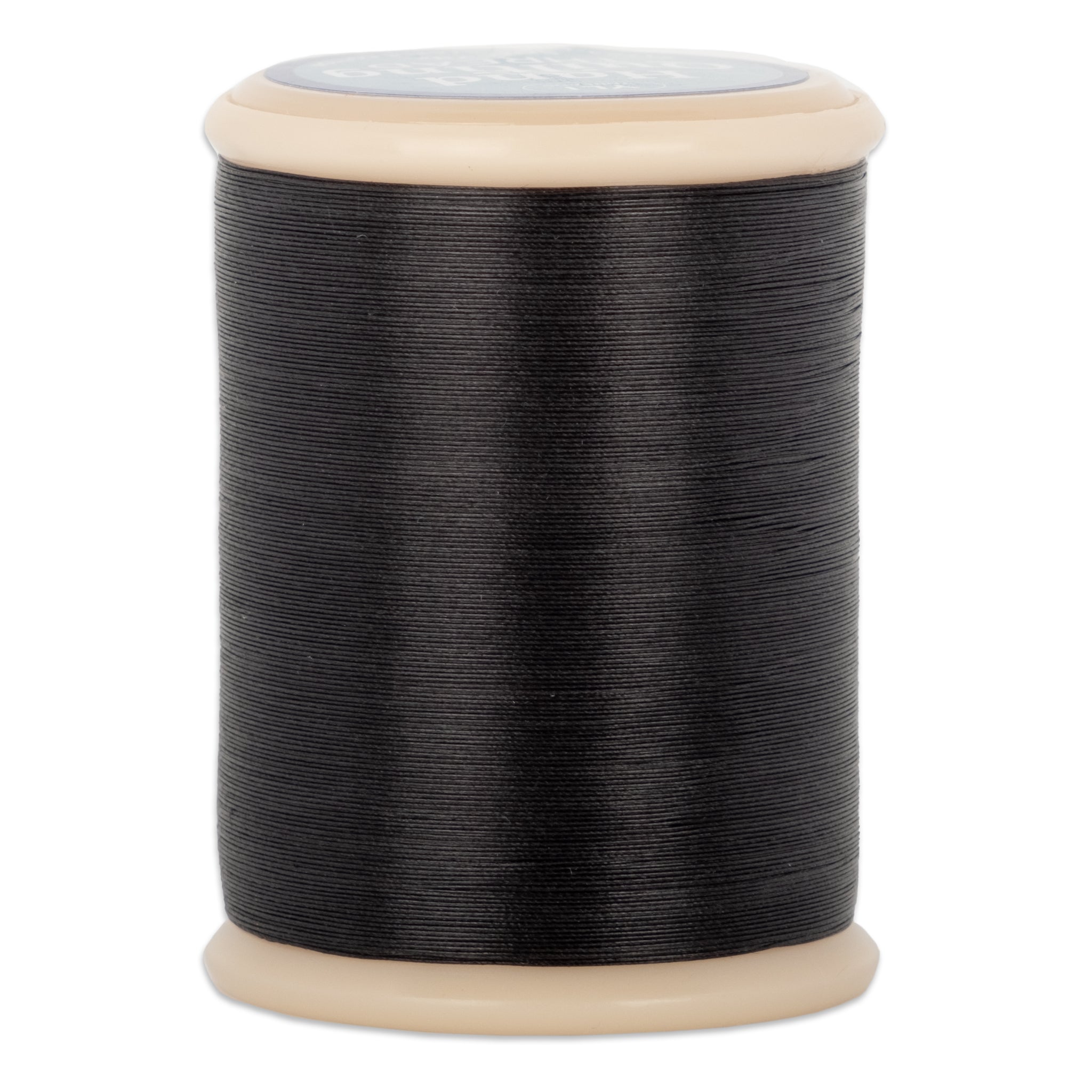 Black hand quilting thread wound on wooden spool with beige plastic ends and gray label on top