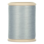 Gray hand quilting thread wound on cream plastic spool with smooth, even finish