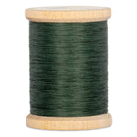 Green hand quilting thread wound on wooden spool with natural wood finish