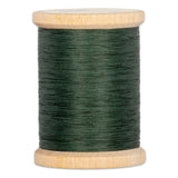 Green hand quilting thread wound on wooden spool with natural wood finish