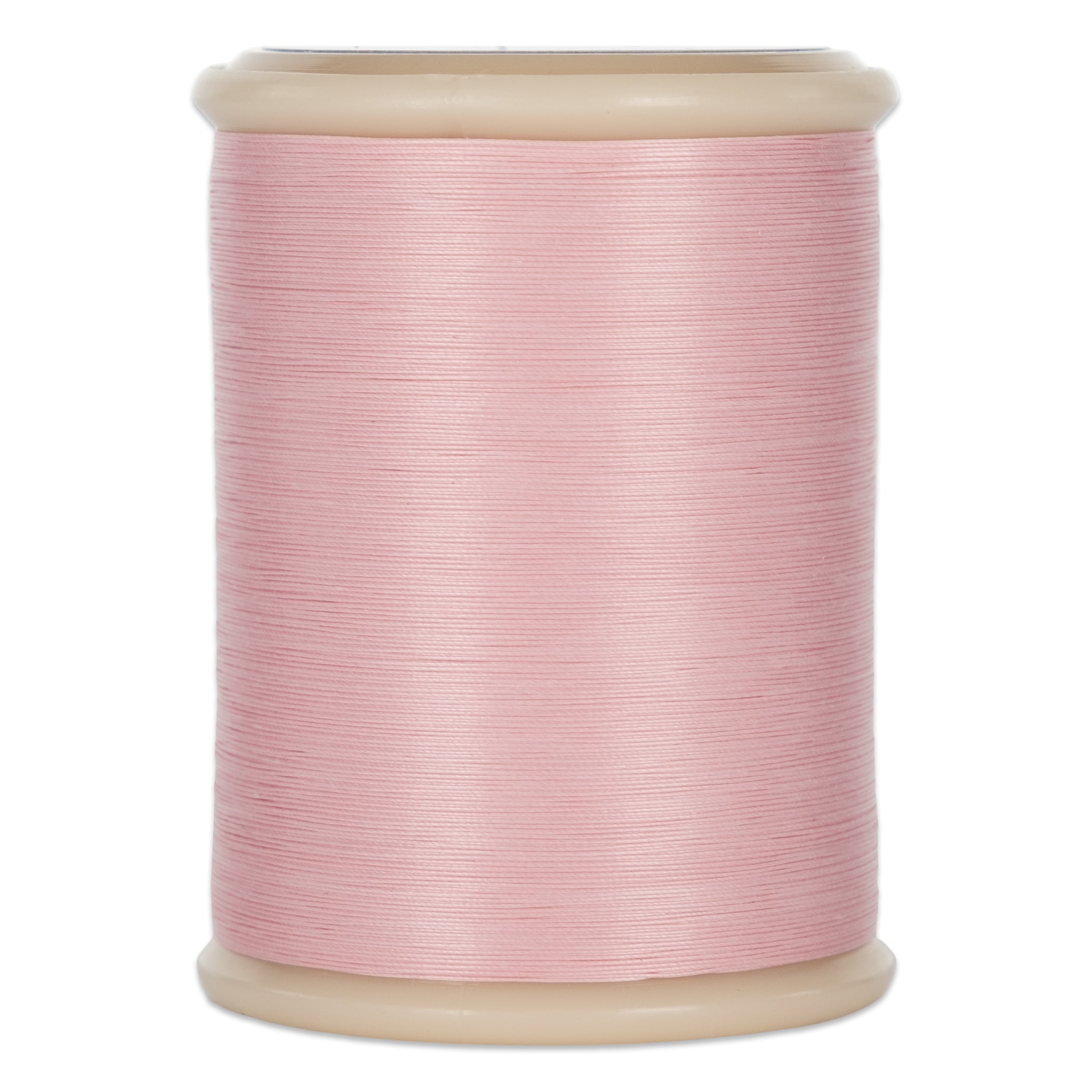 Pink hand quilting thread wound on cream plastic spool with visible thread texture