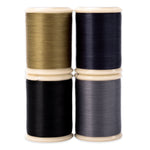 Four spools of cotton hand quilting thread in brown, black, and gray and dark blue 500 yd spools