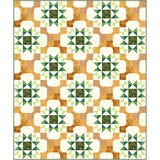 Harvest Stars Batik Quilt Kit featuring repeating star blocks in autumn colors of orange, gold, green, and cream with batik fabric textures.