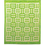 Green and cream batik quilt with geometric maze-like pattern featuring interlocking rectangular blocks and quilted texture
