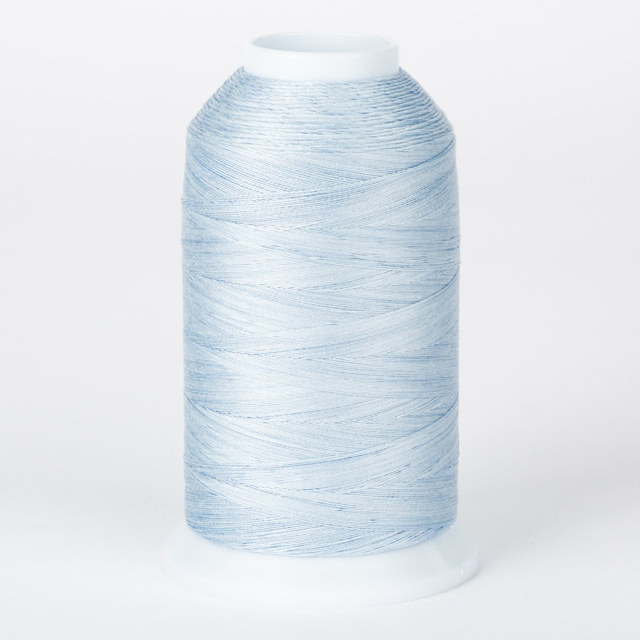 Light blue thread wound on white plastic cone with tapered shape