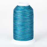 Blue variegated embroidery thread on white cone spool with multiple shades of blue and teal creating a marbled effect