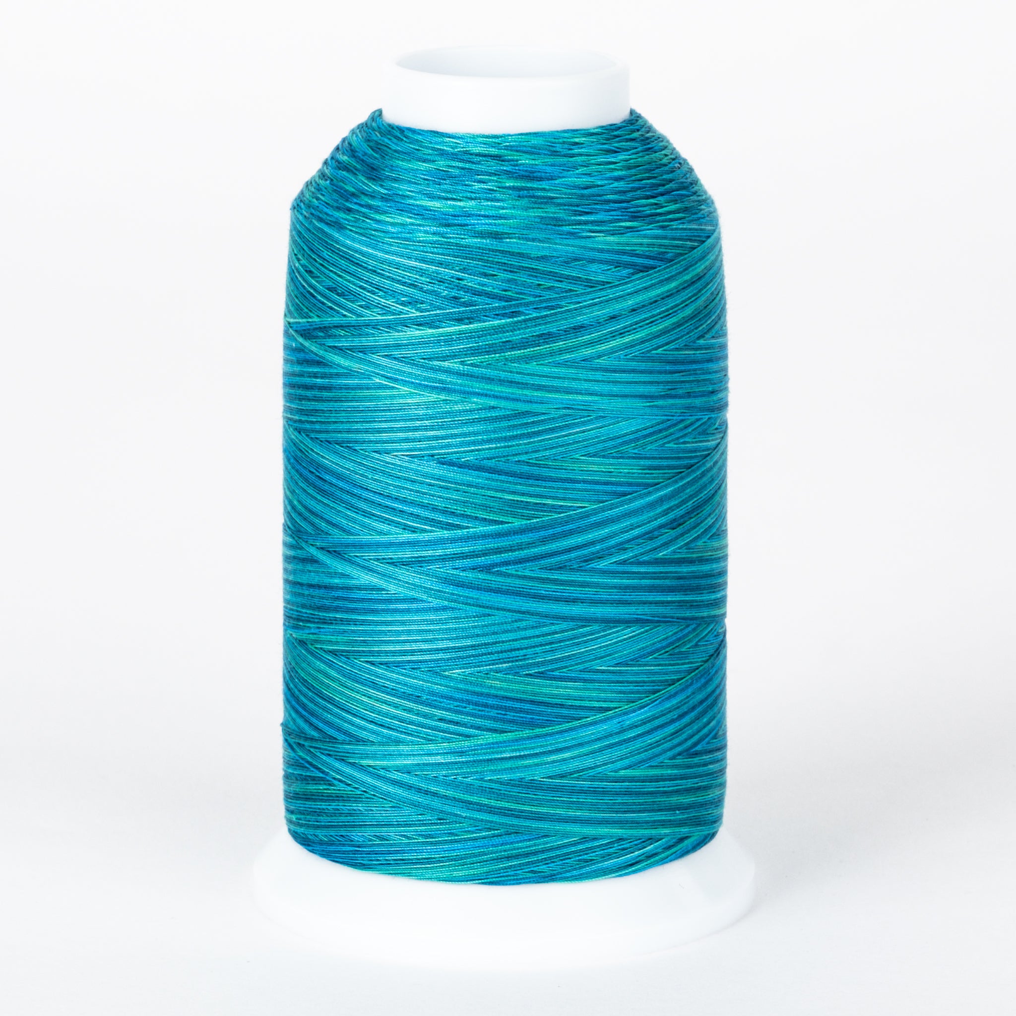 Blue variegated thread cone with multiple shades of turquoise and teal wound in crossing patterns