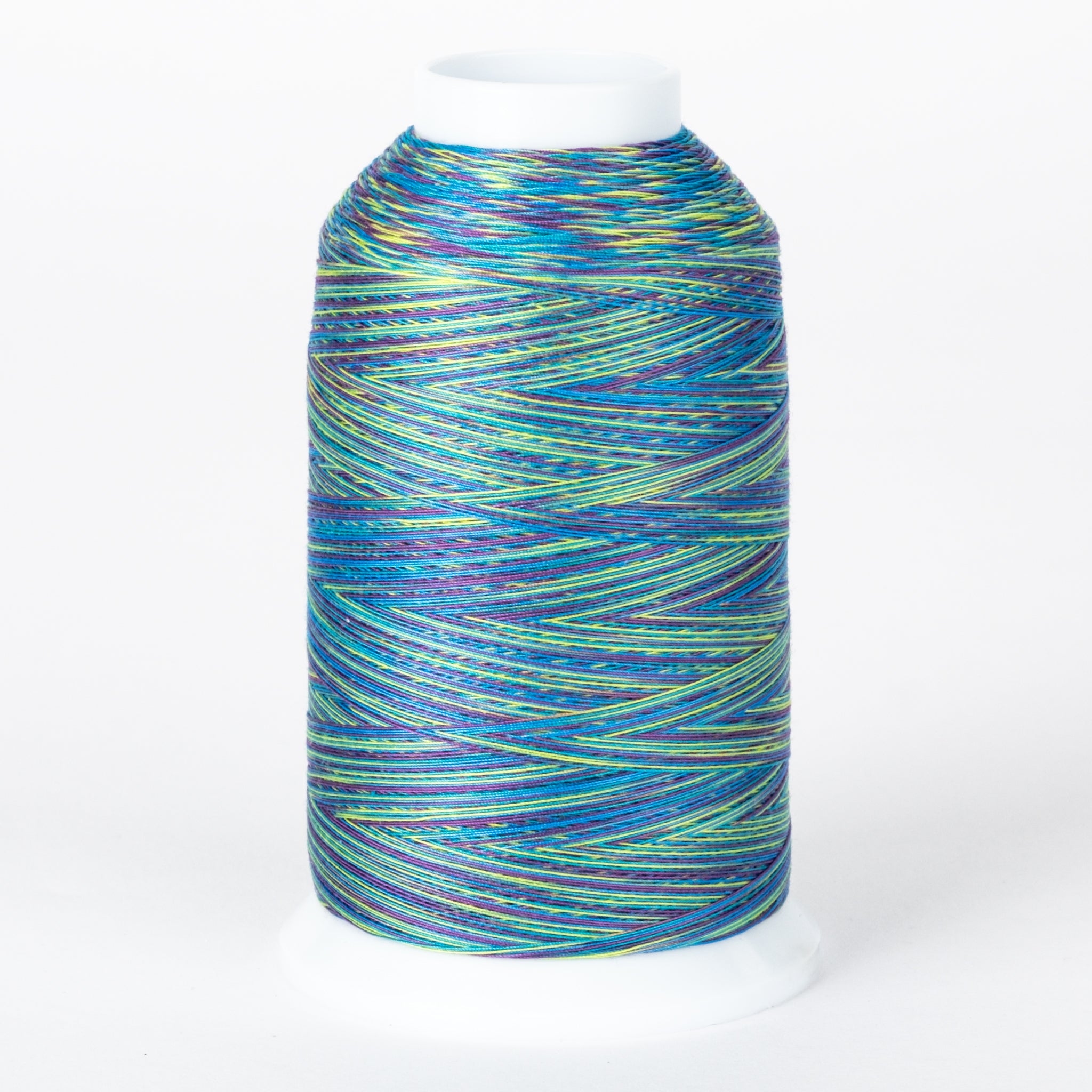 Multicolored variegated thread on white cone featuring blue, green, yellow, and purple strands wound together