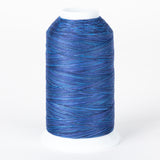 Blue variegated thread on white plastic cone with multiple shades of blue creating a marbled effect