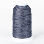Nightfall variegated thread on white cone with dark blue, gray, and light blue multicolored strands wound in diagonal pattern