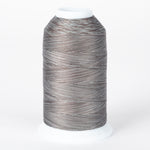 Gray and brown variegated thread cone with white plastic cap, multicolored fossil-toned thread on industrial spool.