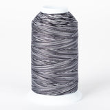 Zebra striped variegated thread on white plastic cone with black and white alternating pattern throughout