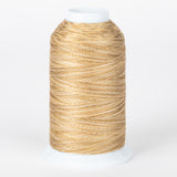 Tumbleweed variegated thread on white cone, showing golden brown and cream twisted strands