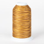 Golden brown variegated thread on white cone with clear protective cap, showing rich amber and tan color variations