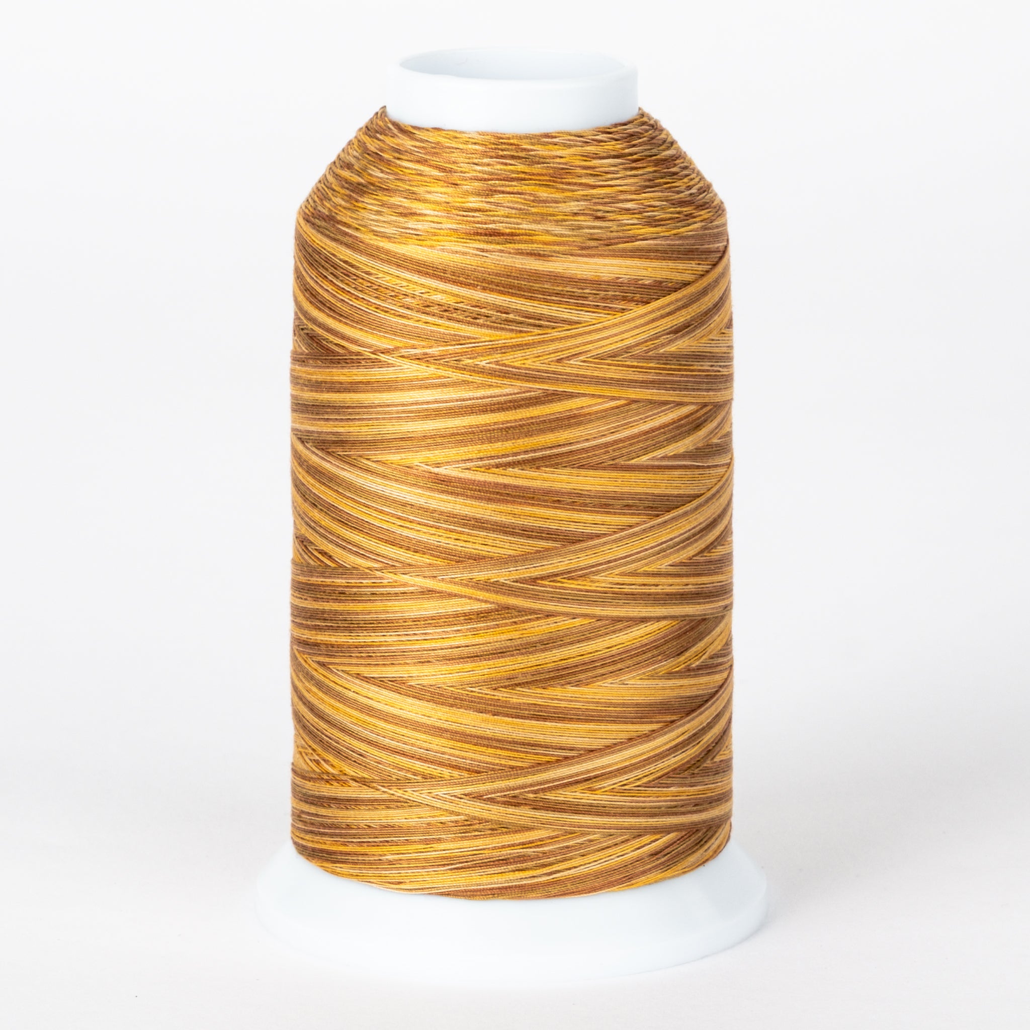 Golden brown variegated thread on white cone with clear protective cap, showing rich amber and tan color variations