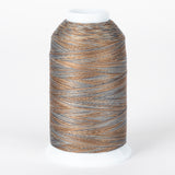 Cobblestone variegated thread cone with brown, gray, and tan colors wound on white plastic spool