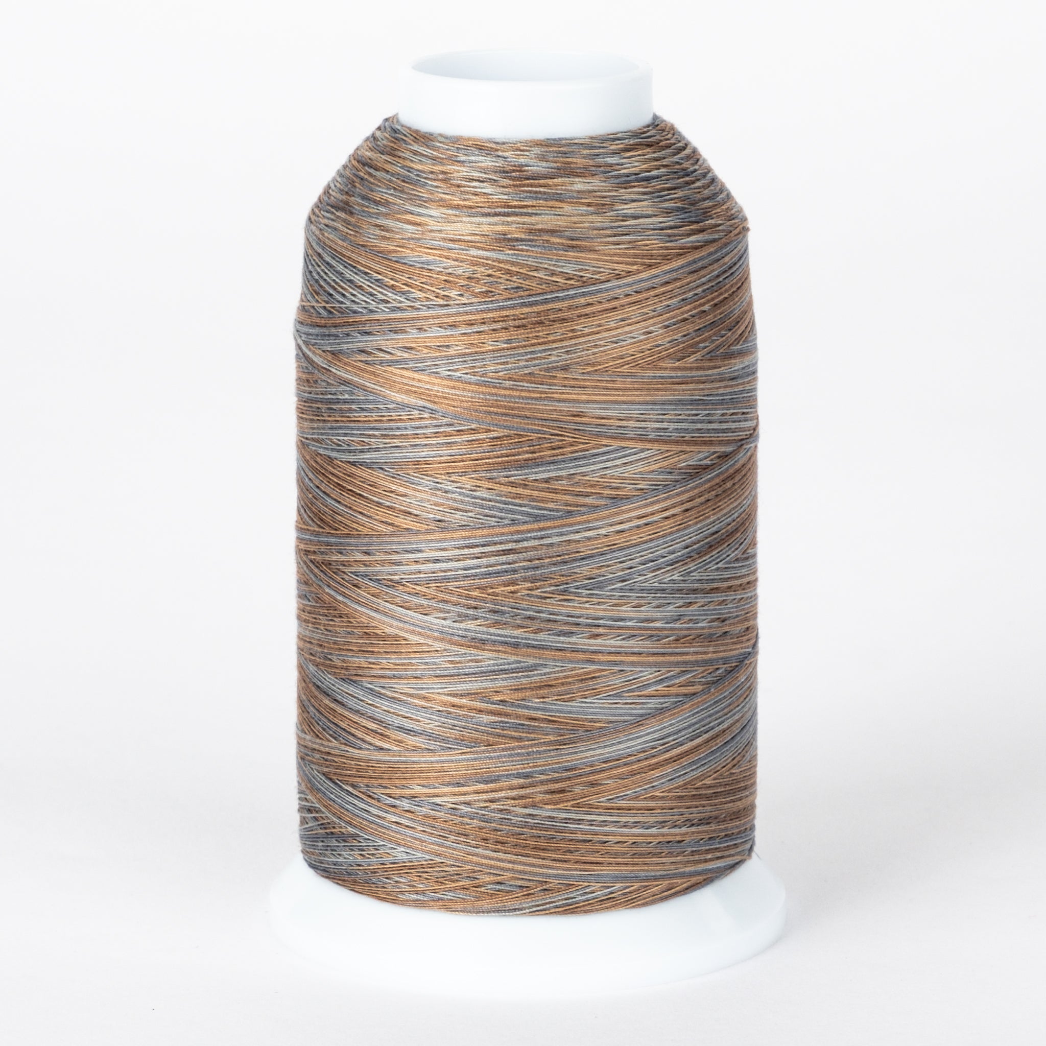 Cobblestone variegated thread cone with brown, gray, and tan colors wound on white plastic spool