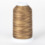 Barnwood variegated thread on white cone, showing brown and tan multicolored strands wound in diagonal pattern