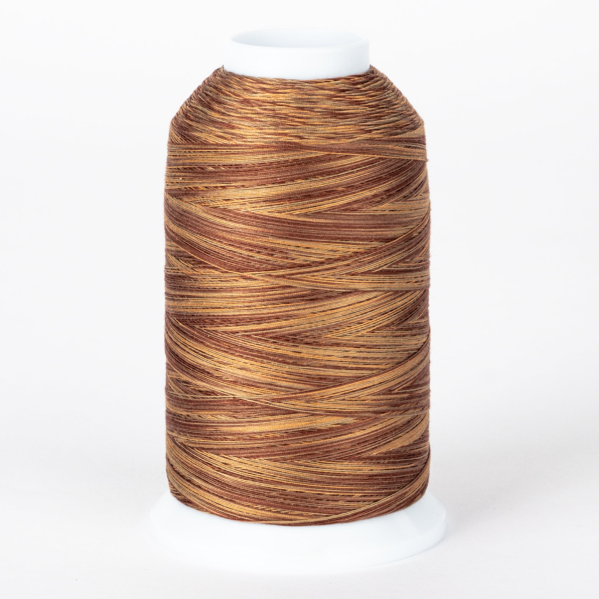Brown and gold variegated thread on white cone spool with visible thread texture and layered winding pattern