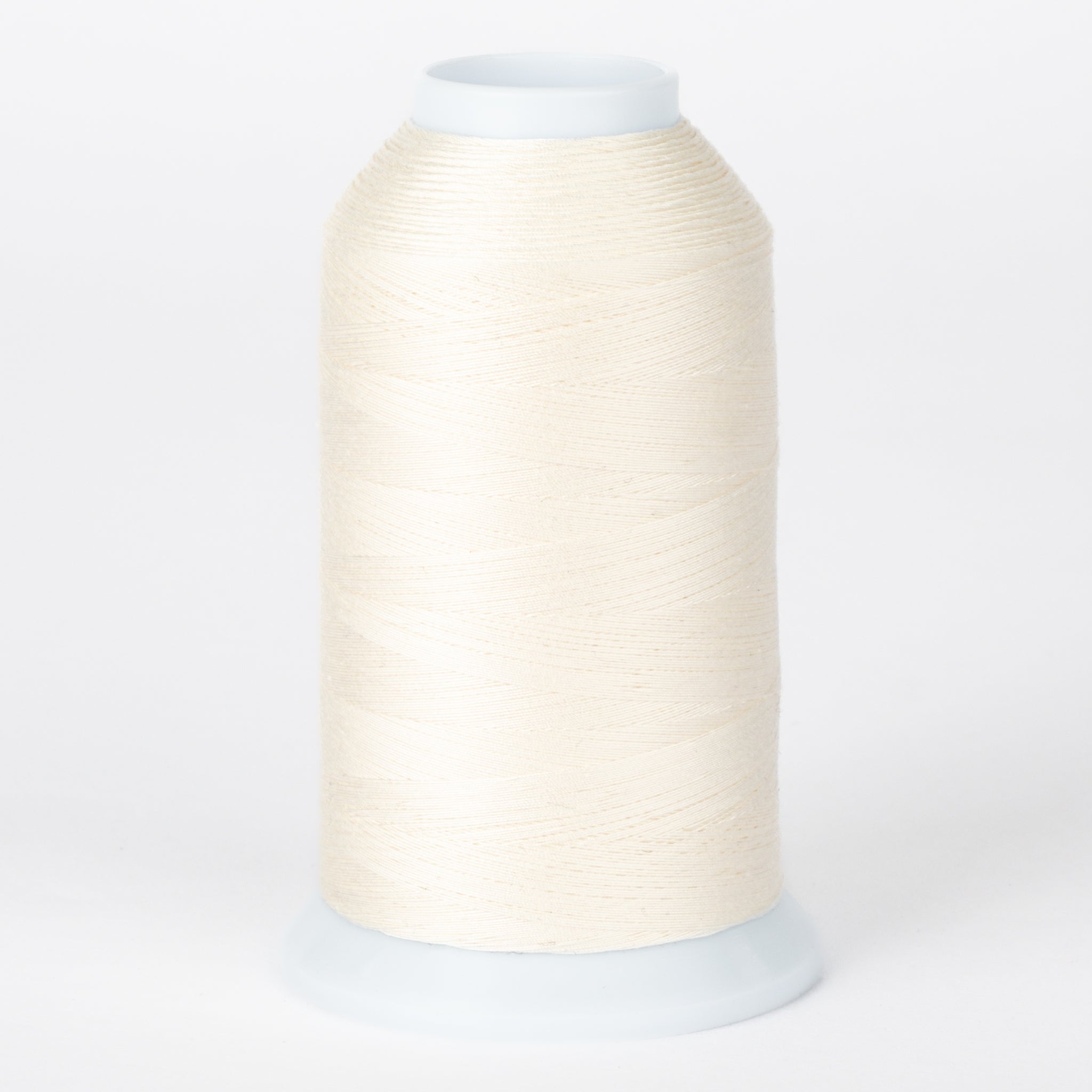 Natural white thread wound on large white cone spool with plastic top and bottom caps