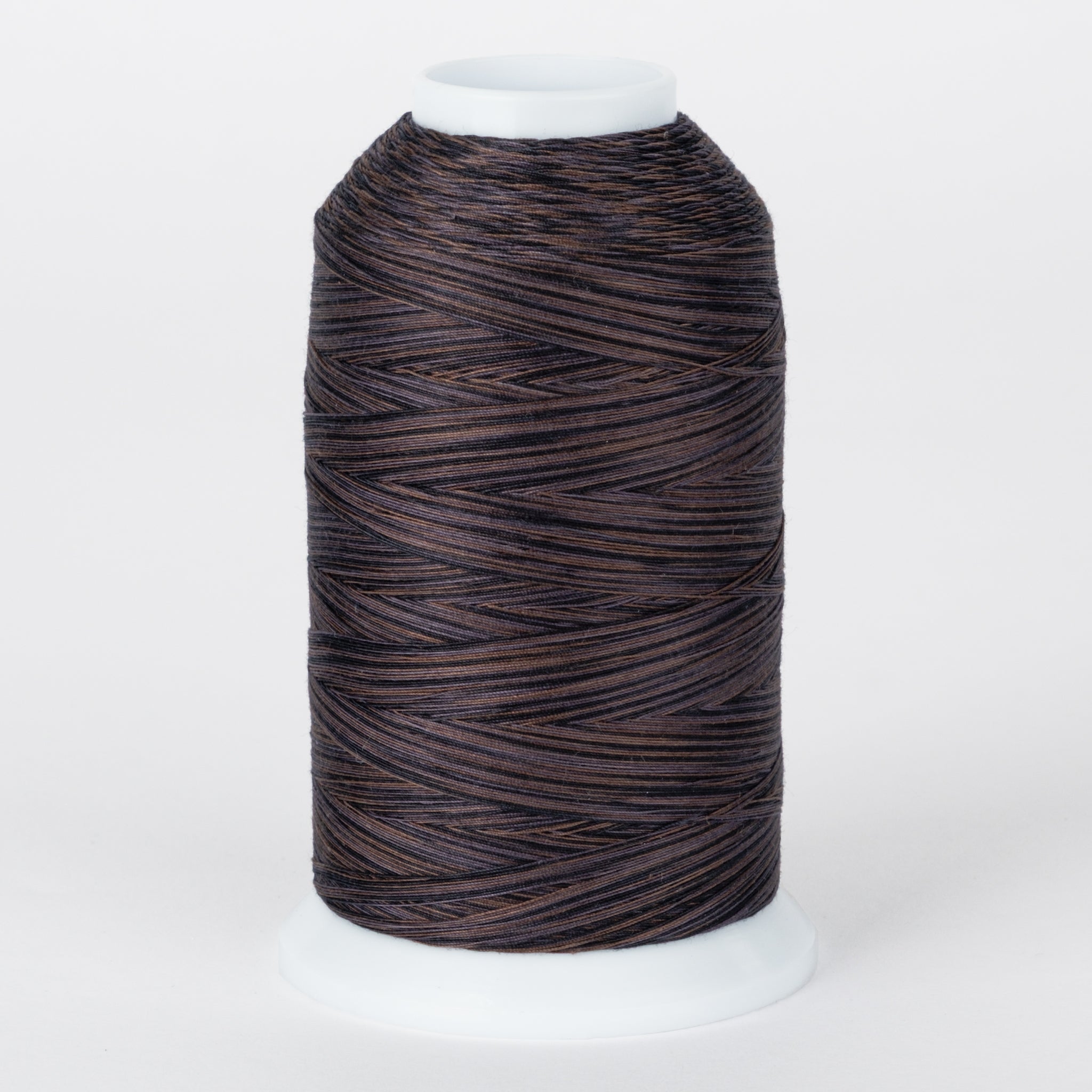 Dark brown and black variegated thread on white plastic cone with multi-toned twisted fibers visible throughout the spool.