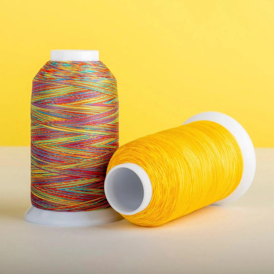 cones of majestic quilting thread against a yellow background