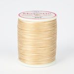 spool of majestic cotton quilting thread #402 sand dollar