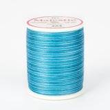 Blue variegated Majestic thread on white plastic spool with pink and white label showing color 424