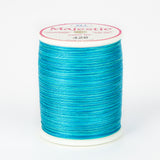 Lagoon blue variegated thread wound on white plastic spool with Majestic brand label showing color number 426