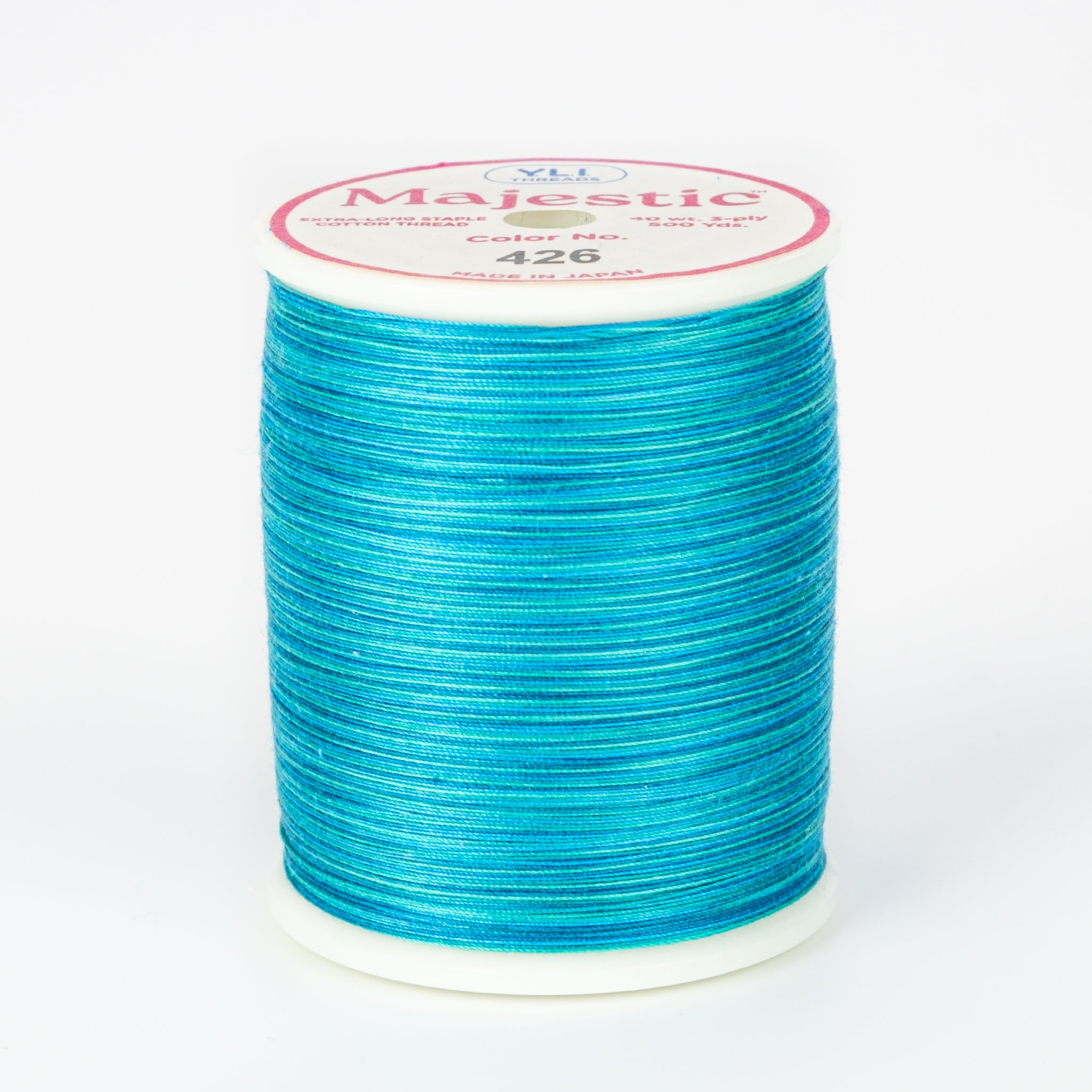 Lagoon blue variegated thread wound on white plastic spool with Majestic brand label showing color number 426