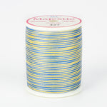 Multicolored blue and yellow variegated thread on white spool with Majestic brand label, color 427 Moonbeam