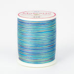 Multicolored thread in blues, purples, yellows on white plastic spool, Majestic brand label, color 428 Aloha.