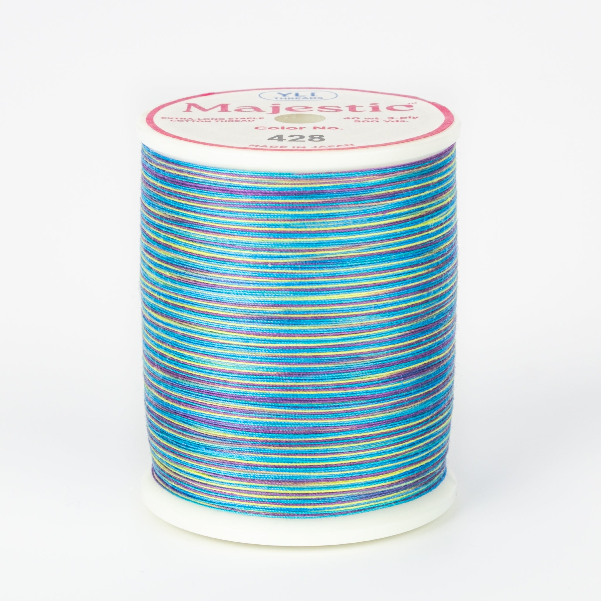Multicolored thread in blues, purples, yellows on white plastic spool, Majestic brand label, color 428 Aloha.