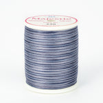 Blue and white variegated Majestic thread on white plastic spool with pink and white label showing color number 430