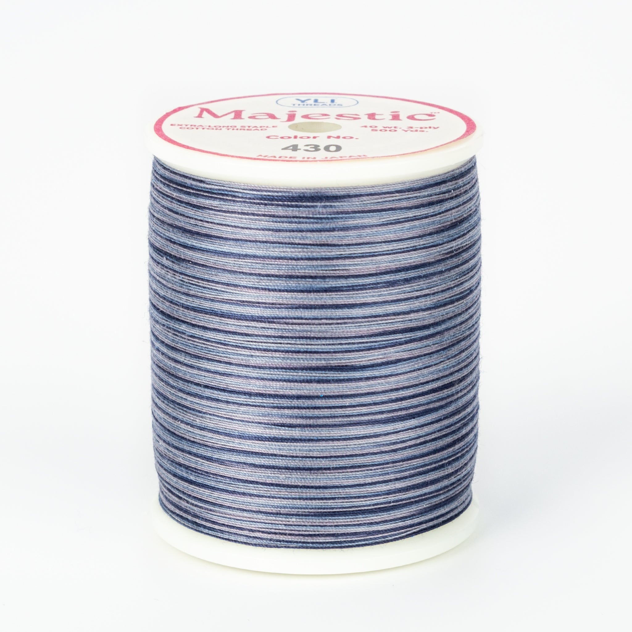 Blue and white variegated Majestic thread on white plastic spool with pink and white label showing color number 430