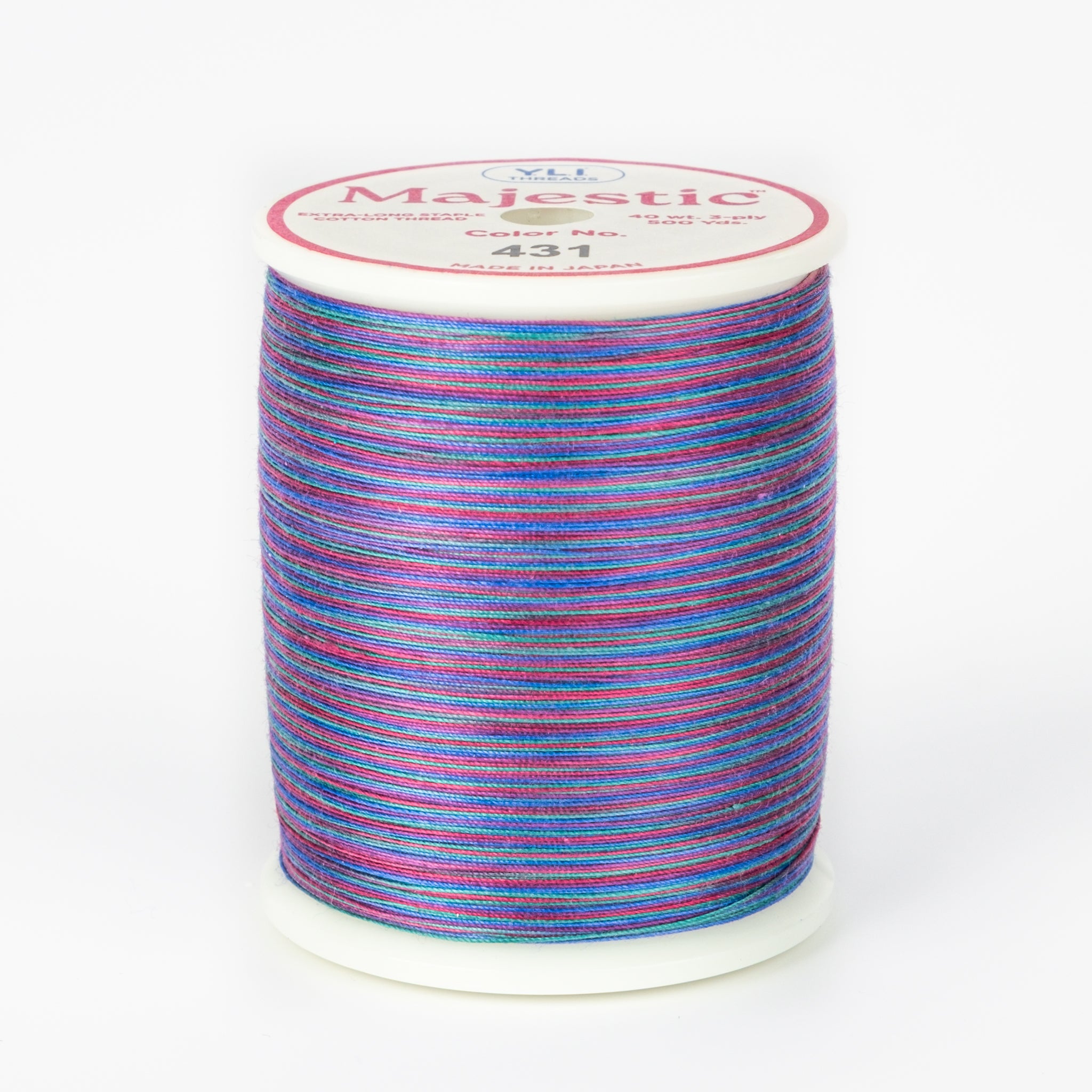 Multicolored variegated thread in blues, purples, and pinks on white plastic spool, Majestic brand, color 431 Treasure Hunt.