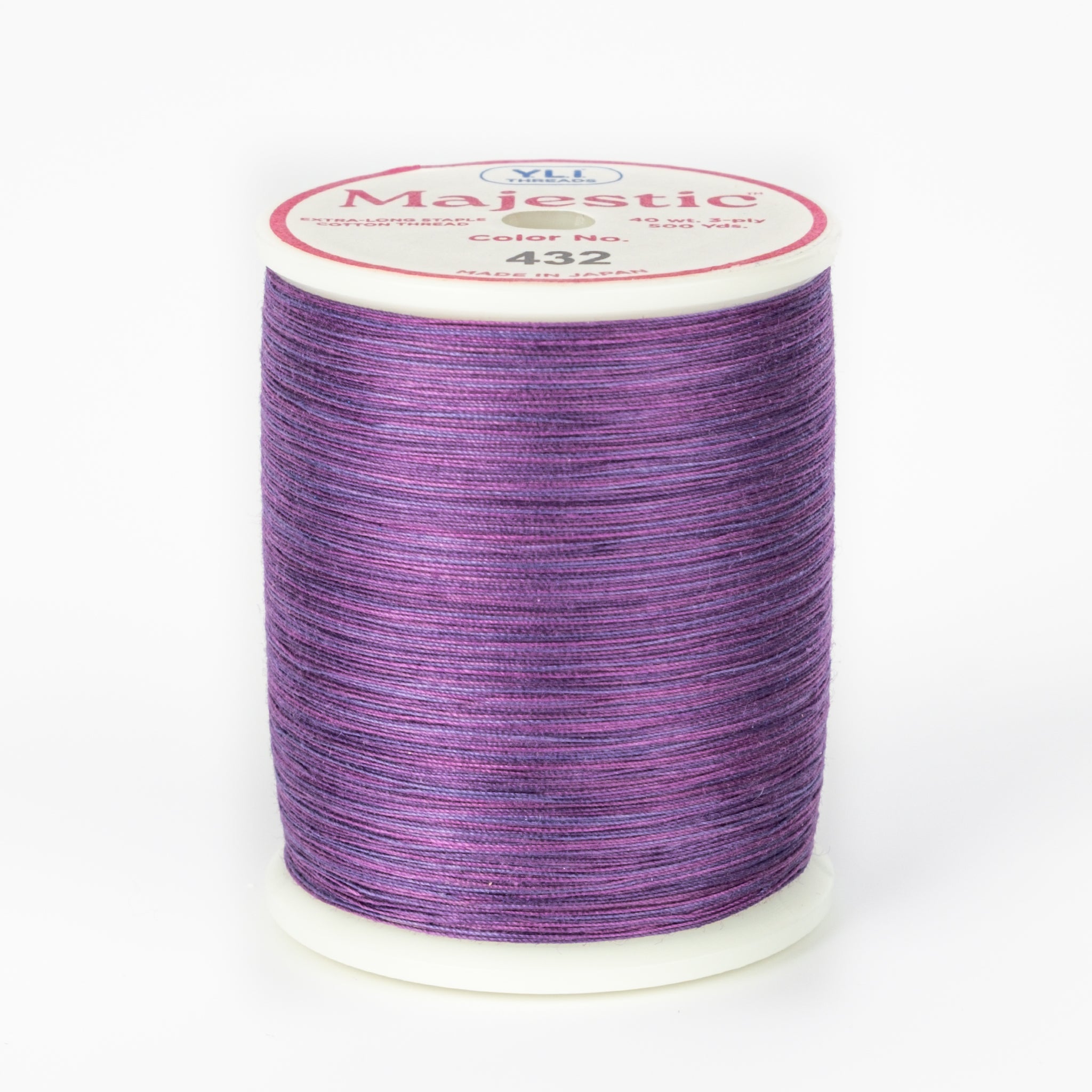 Purple and pink variegated Majestic thread on white spool with cream label showing color number 432