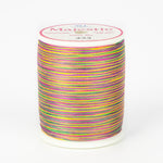 Multicolored variegated thread on white Majestic spool with bright rainbow stripes in pink, yellow, green, and purple.
