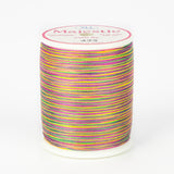 Multicolored variegated thread on white Majestic spool with bright rainbow stripes in pink, yellow, green, and purple.