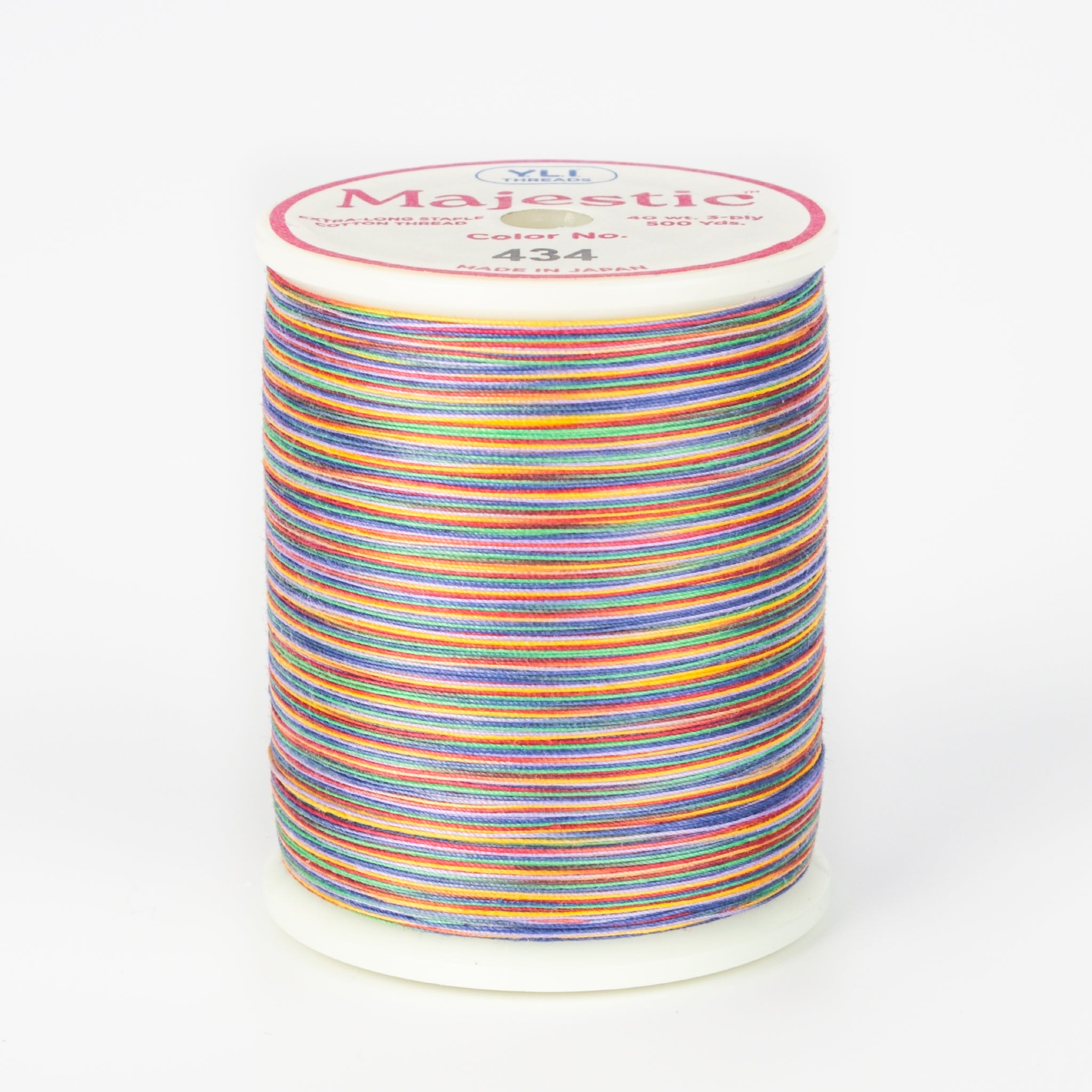 Rainbow variegated thread on white plastic spool with Majestic brand label, color number 434