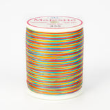 Multicolored variegated thread on white Majestic spool with bright rainbow stripes in orange, blue, pink, yellow