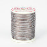 Variegated brown and gray Majestic thread on white plastic spool with pink and white label showing color number 436